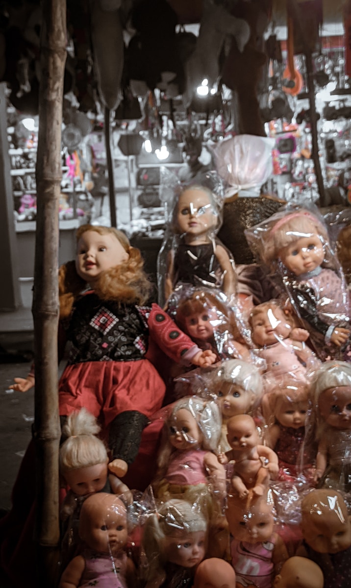a pile of dolls sitting next to each other